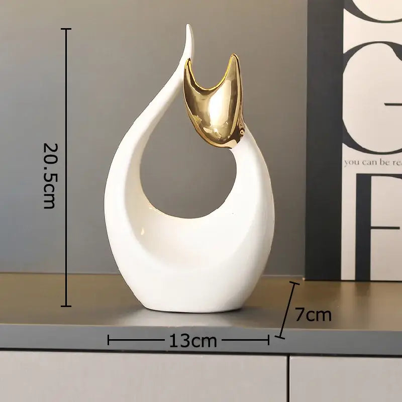 Modern white ceramic kitten statue with gold ears featuring an abstract flowing design for living room decor