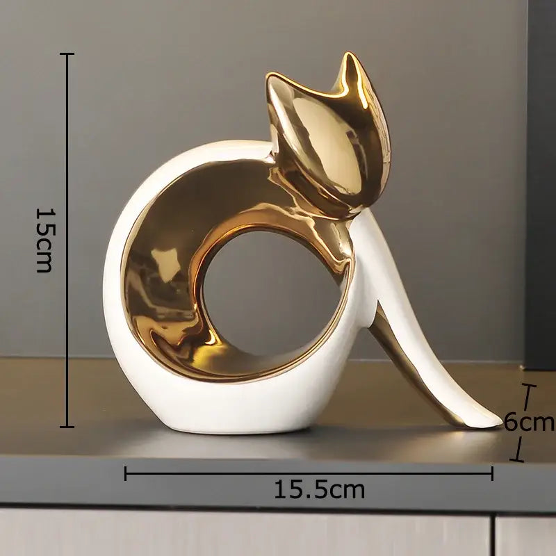 A sleek modern ceramic kitten statue with a glossy white base and gold accents for living room decor