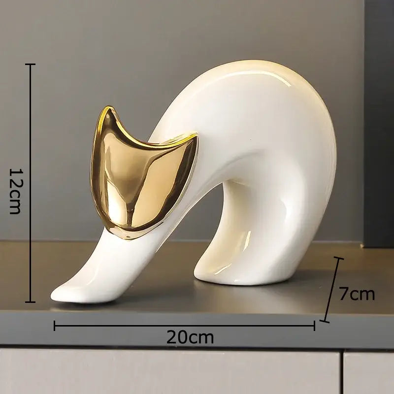 A sleek white ceramic kitten statue with polished gold face measuring 20cm by 12cm for living room decor