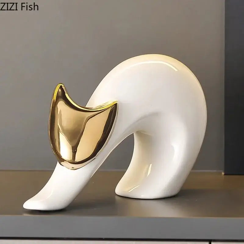A sleek white ceramic kitten statue with a glossy gold metallic face by zizi fish for modern living room decor
