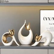 Three elegant white ceramic kitten statues with gold-accented ears for modern living room decor