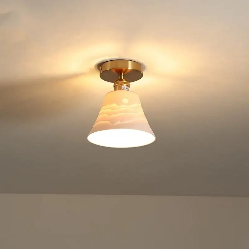 Modern white ceramic led ceiling light with warm-toned bell-shaped glass and brass finish for balcony decorbites ceramic led
