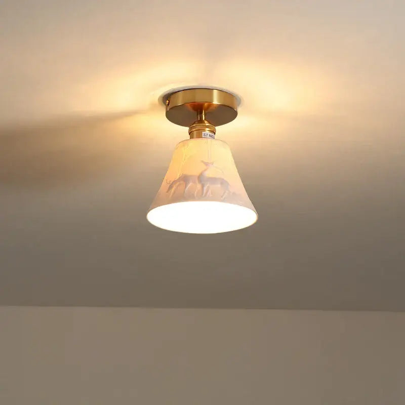 Modern white ceramic led ceiling light with gold base and cream glass shade featuring deer silhouettes for balcony decorbites ceramic led