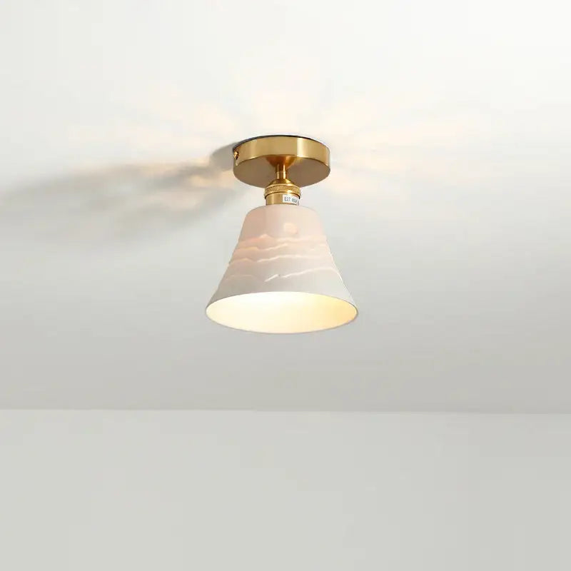 Modern white ceramic led ceiling light for balcony with warm-toned bell-shaped lampshade and gold base decorbites ceramic led ceiling