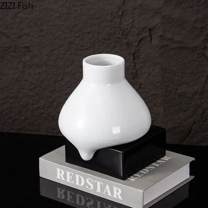 A sleek glossy white ceramic liquid vase with a modern bulbous shape and narrow neck by decorbites ceramic