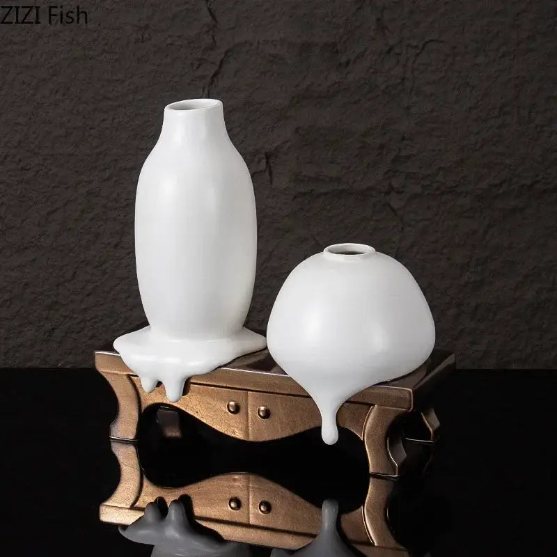 Two white glossy ceramic liquid vases by decorbites ceramic featuring tall slender and shorter rounded designs for modern decor