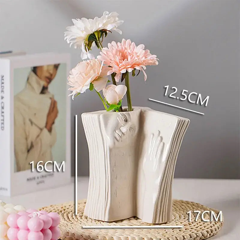 Cream-colored ceramic man face vase shaped like an open book for modern living room decor by decorbites ceramic man face