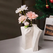 Modern white ceramic man face book vase holding artificial white and pink flowers for living room decorbites ceramic man face decor