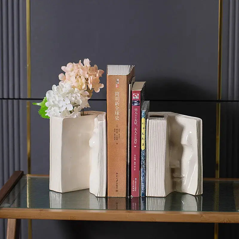 Cream-colored ceramic man face bookends shaped like open books for modern living room decor by decorbites ceramic man face