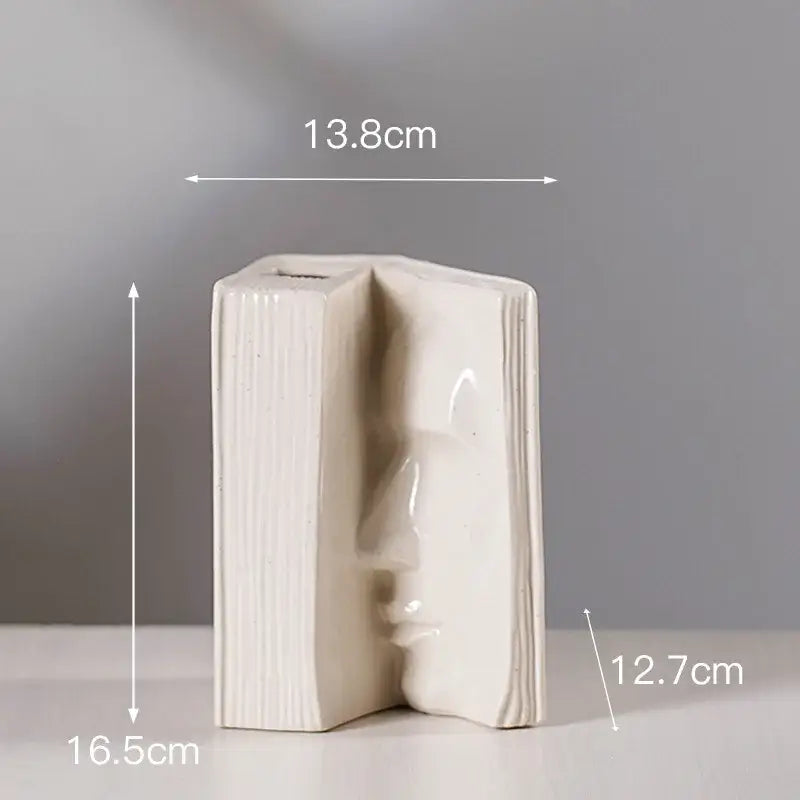 Cream-colored ceramic man face book vase by decorbites for modern living room decor and stylish storage solution