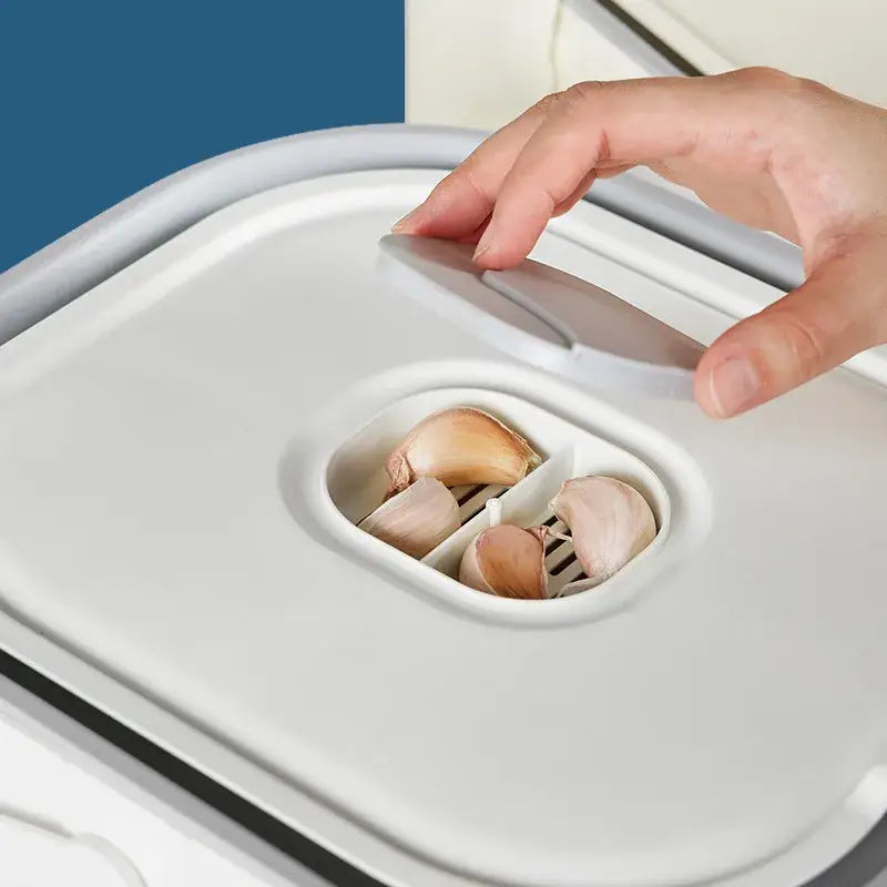 Modern white ceramic rice food storage container with hinged lid and compartments holding whole garlic cloves for food storage