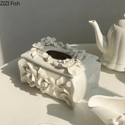 Modern white ceramic tissue box featuring intricate three-dimensional camellia flower sculptures for living room use