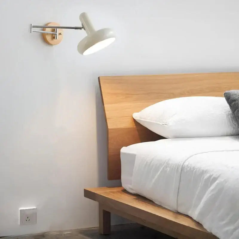 A sleek white ceramic wall lamp with a wooden base and adjustable arm for modern decorbites cream iron art decor