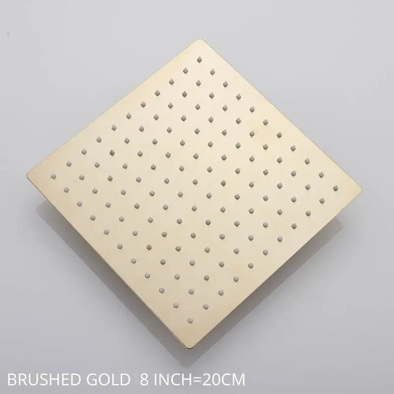 Modern white chrome rainfall shower head with brushed gold square design and evenly spaced perforations for rainfall shower
