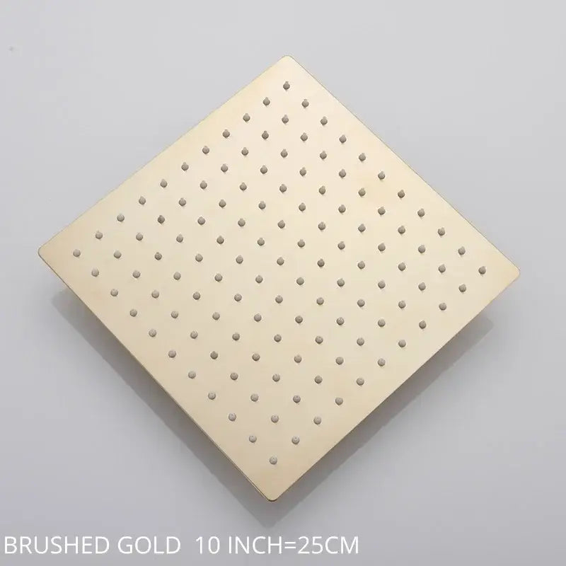 Brushed gold square rainfall shower head with evenly spaced perforations for a modern bathroom fixture