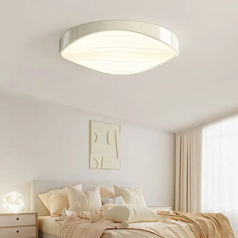 Modern white circular chandelier with wave textured decorbites circular chandelier featuring silver oval frame and soft lighting