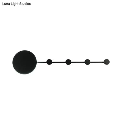 Black minimalist wall lamp with large spherical fixture and four smaller spheres along elongated arm bulb included light fixture
