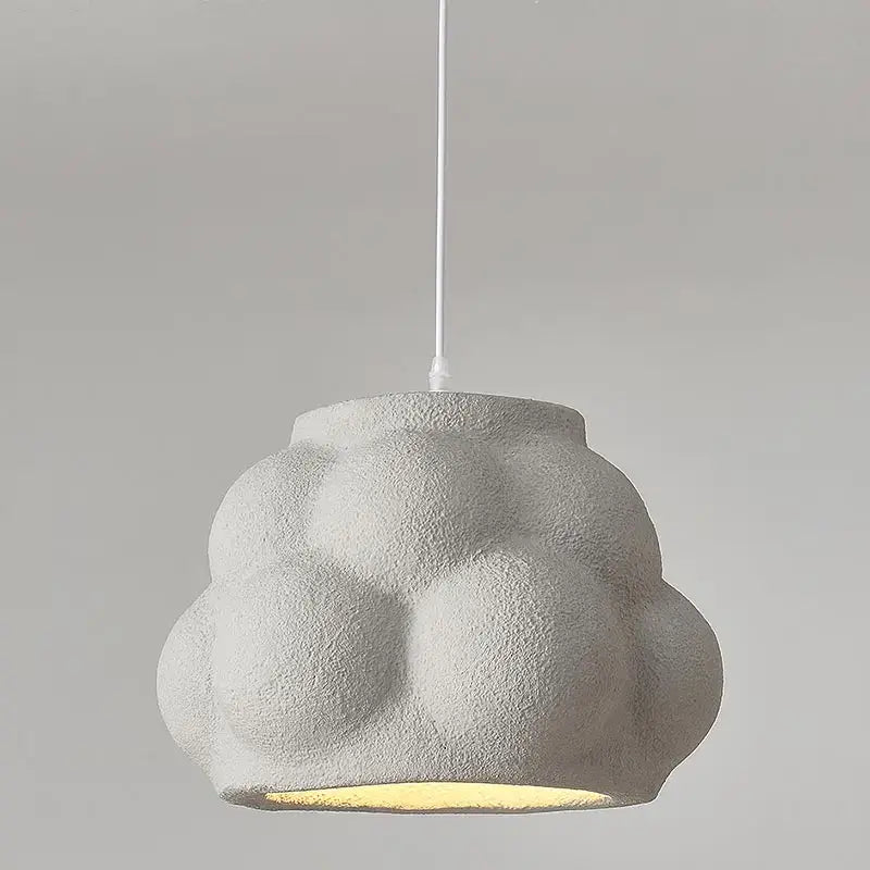 Modern white cloud pendant light with textured matte finish and warm yellow glow for dining room decorbites green nordic