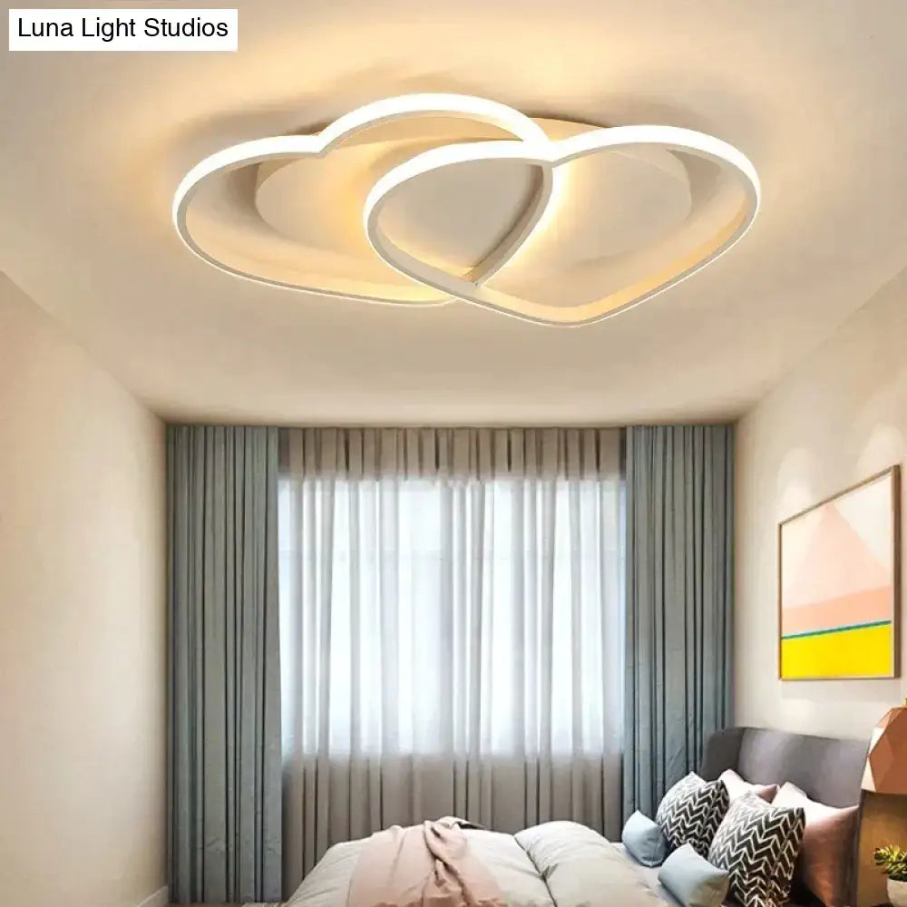 Modern white coffee pendant light with sleek intertwined heart design for bedroom illumination