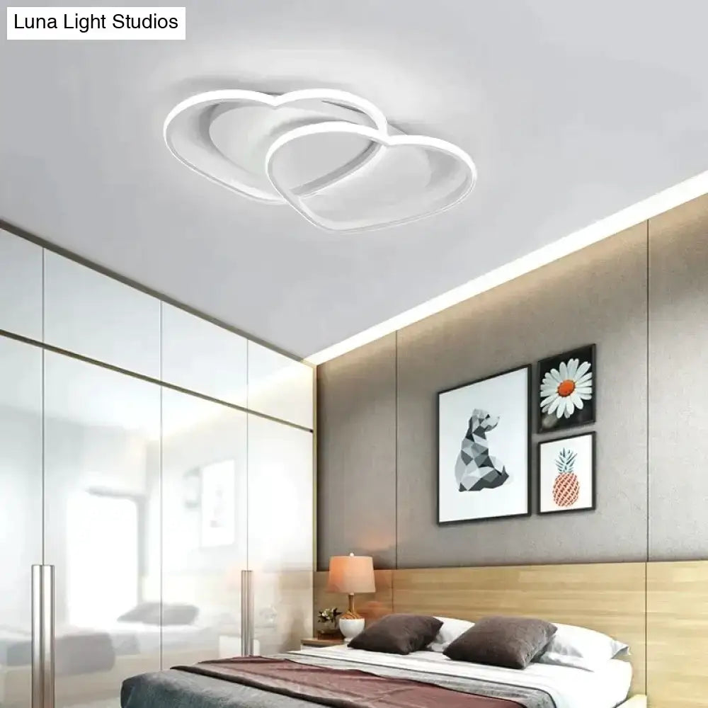 Modern white coffee pendant light with sleek intertwined circular led design for bedroom lighting