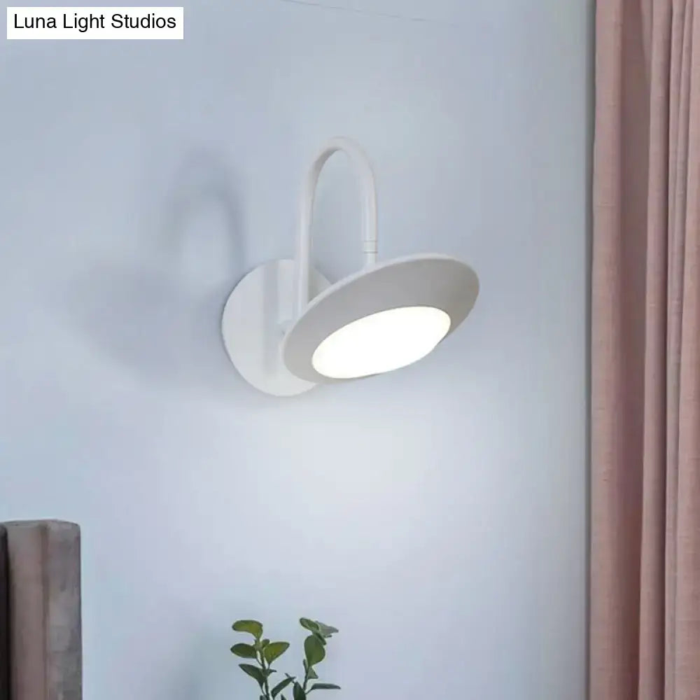Modern white and coffee wall sconce lamp with sleek curved arm and circular led light for bedroom use