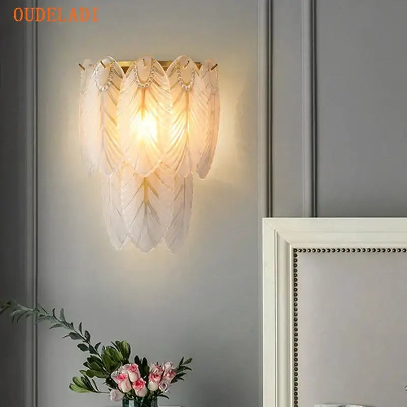 Elegant white crystal feather wall lamp with gold pearl metal frame and delicate pearl accents for bedroom decorbites crystal feather sconce