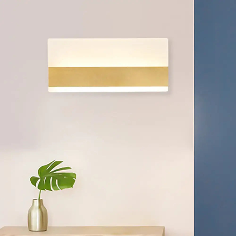 Modern white cuboid design wall sconce with sleek gold stripe delivering warm white light for bedroom use