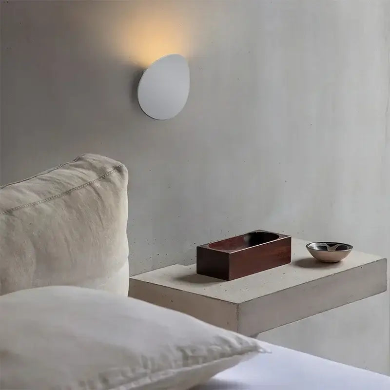 Minimalist white curved led wall lamp with a soft warm glow ideal as a modern led wall lamp for bedroom lighting