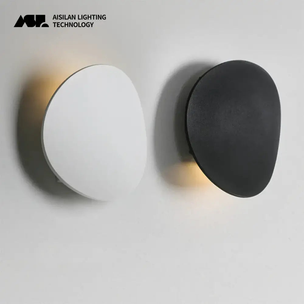 Modern white curved led wall lamp with sleek matte black minimalist oval shapes and warm ambient lighting for bedroom