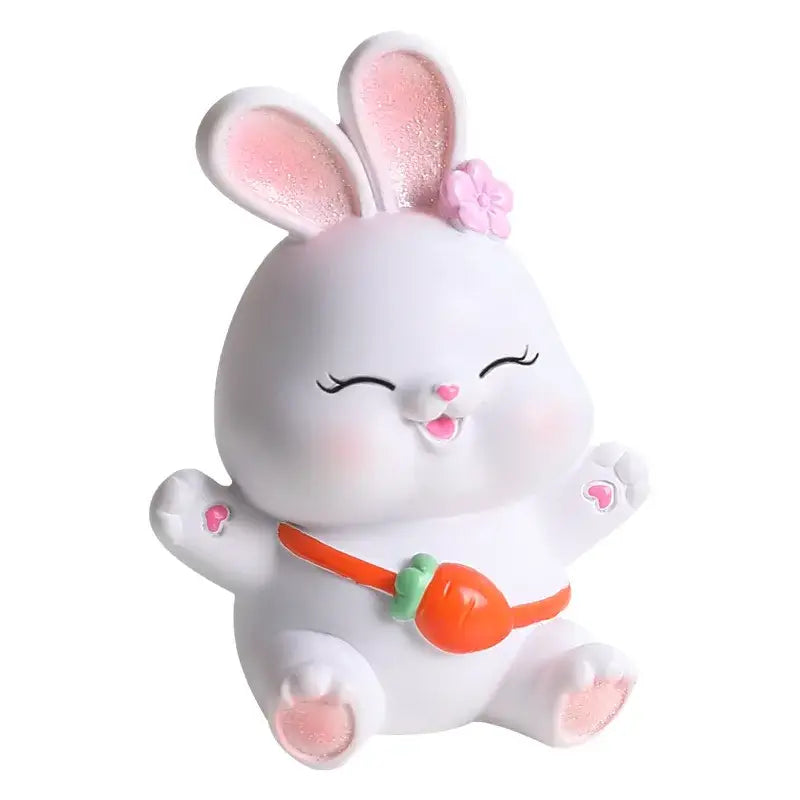 Modern white cute bunny figurine sculpture with pink glitter ears, flower headpiece, and orange carrot belt decor