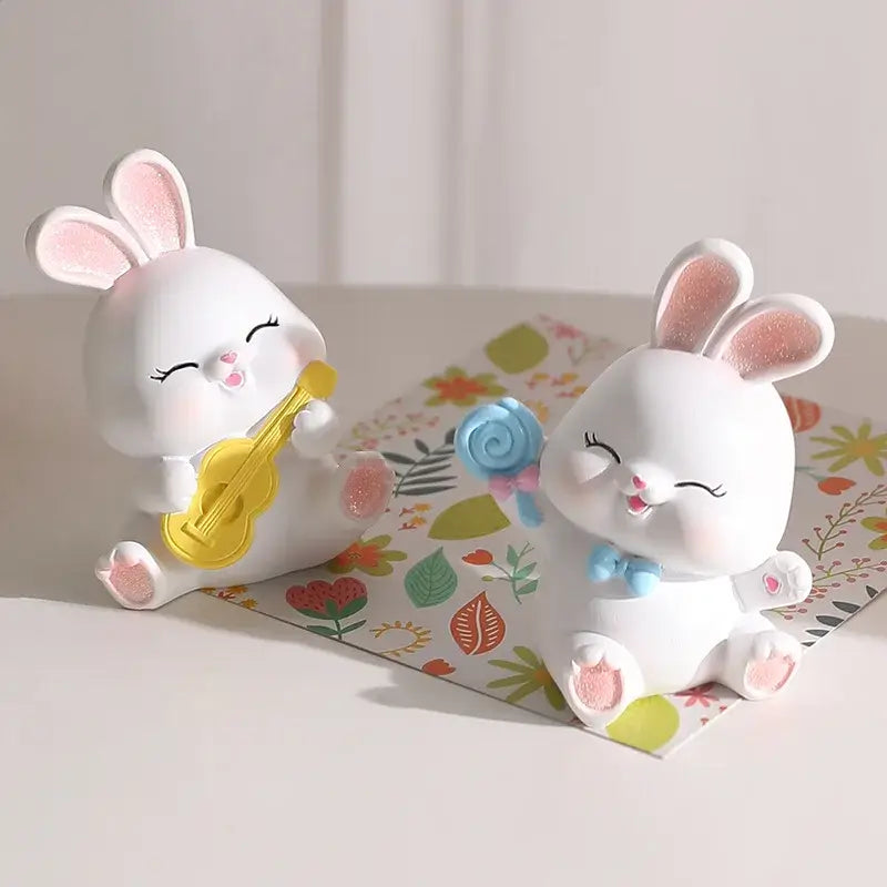 Modern white cute bunny figurine sculpture with pink details holding a yellow ukulele and blue lollipop decor