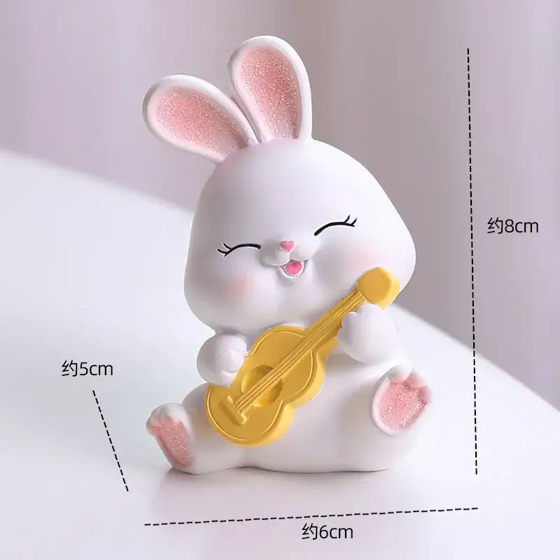Modern white cute bunny figurine sculpture made of resin with pink glitter ears holding a yellow ukulele for decor