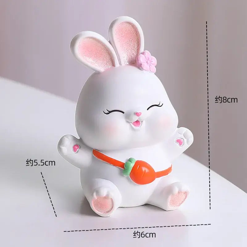 Modern white cute bunny figurine sculpture in ceramic with pink glitter ears and orange carrot belt for bedroom decor