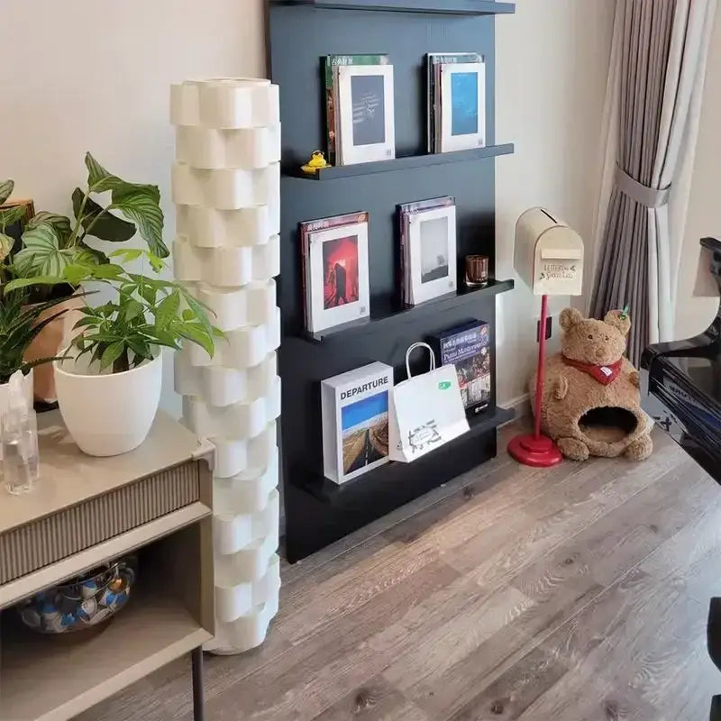 Modern white cylindrical vertical floor lamp with tall stacked geometric ceramic pillar for living room use