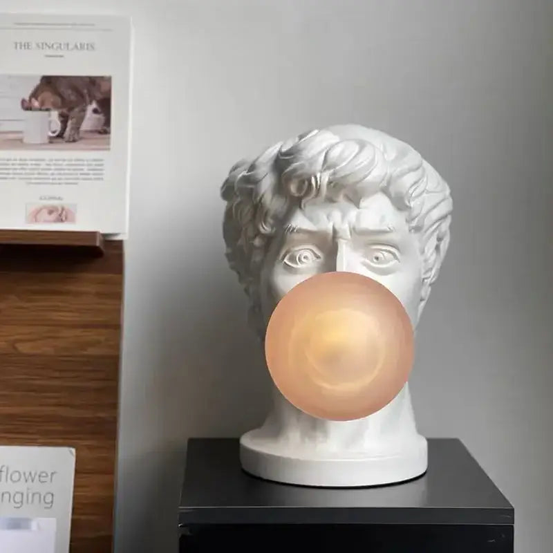Modern white david sculpture table lamp with white marble-style bust and glowing peach bubble light decorbites david sculpture