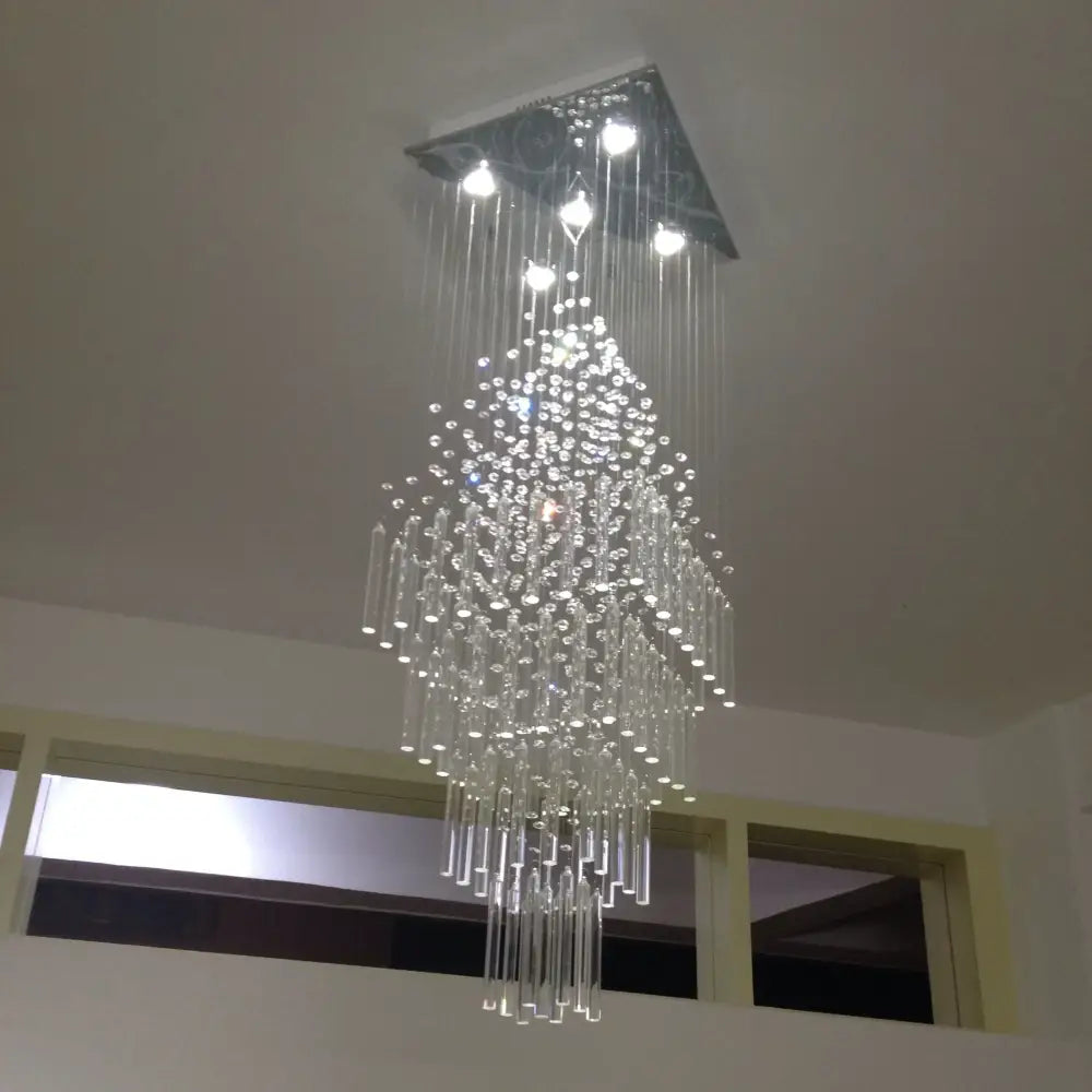 A modern white decorbites crystal ceiling chandelier with a square metal mount and cascading clear glass rods