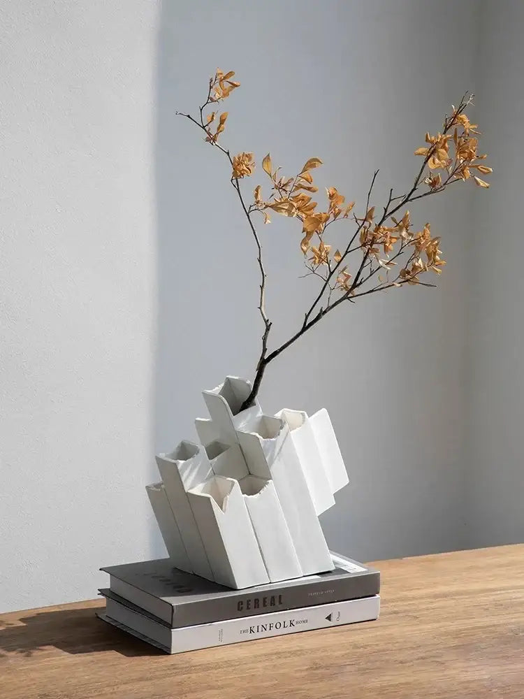 Modern white decorbites geometric ceramic vase with block splicing design holding dried golden leaves for home decor