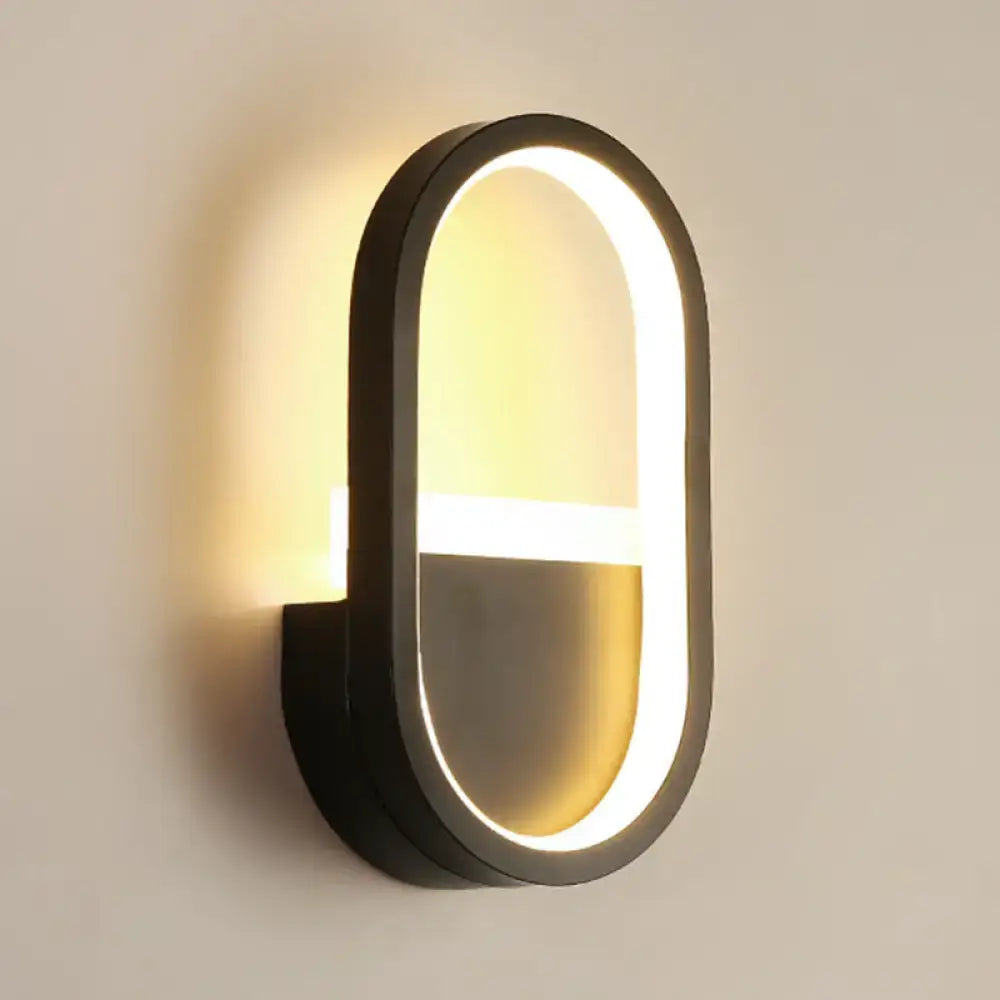 Modern black elliptical led wall lamp with glowing oval frame designed as a bedroom sconce for ambient lighting