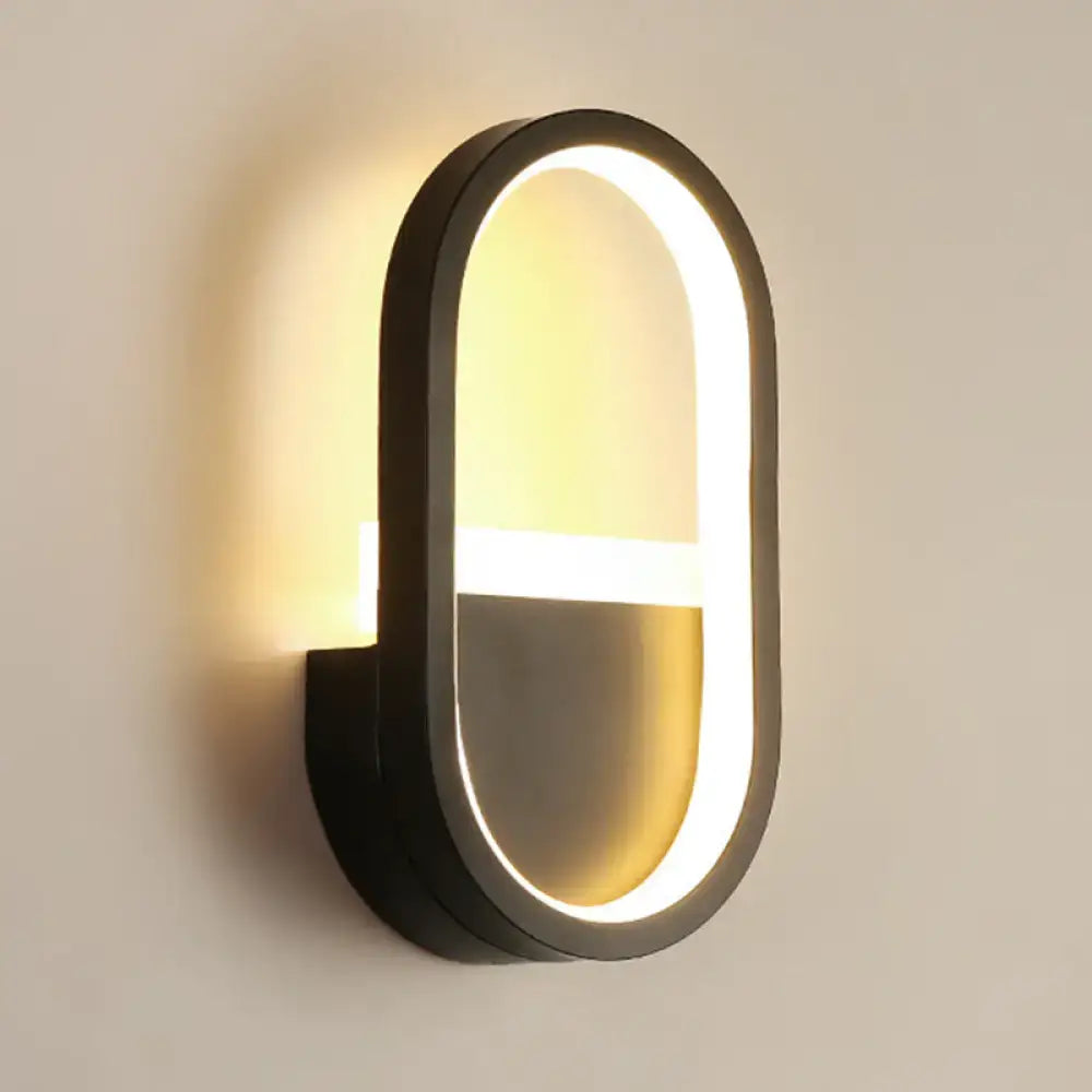 Modern black elliptical led wall lamp with sleek minimalist design and warm lighting for bedroom sconce use