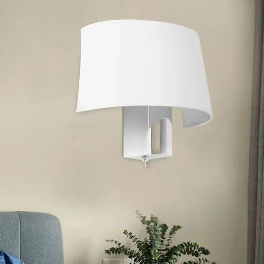 Modern white fabric sconce with a curved shade providing a sleek wall lighting idea for bedroom walls