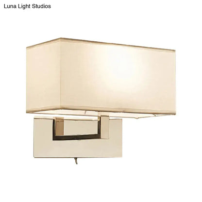 Modern white wall sconce with cream fabric shade and polished chrome frame for bedroom wall light