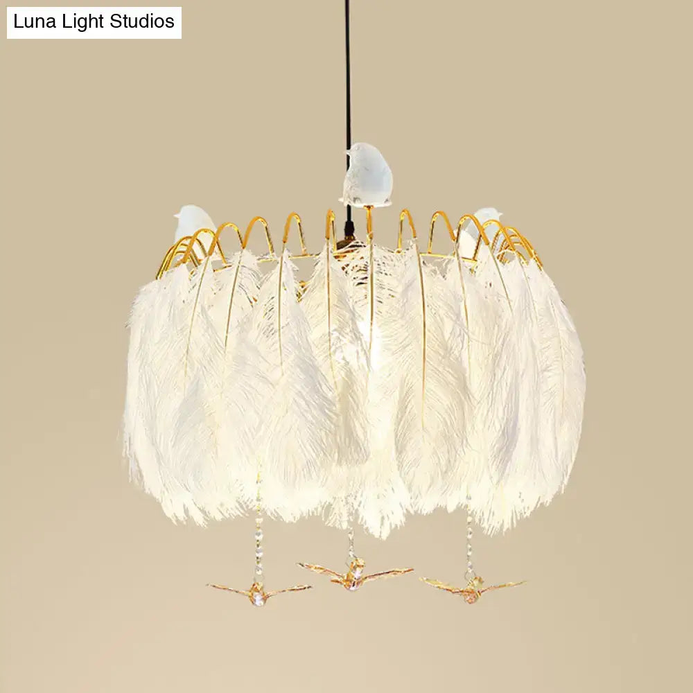 Modern white feather chandelier with gold wire accents and three small bird figurines for living room pendant light