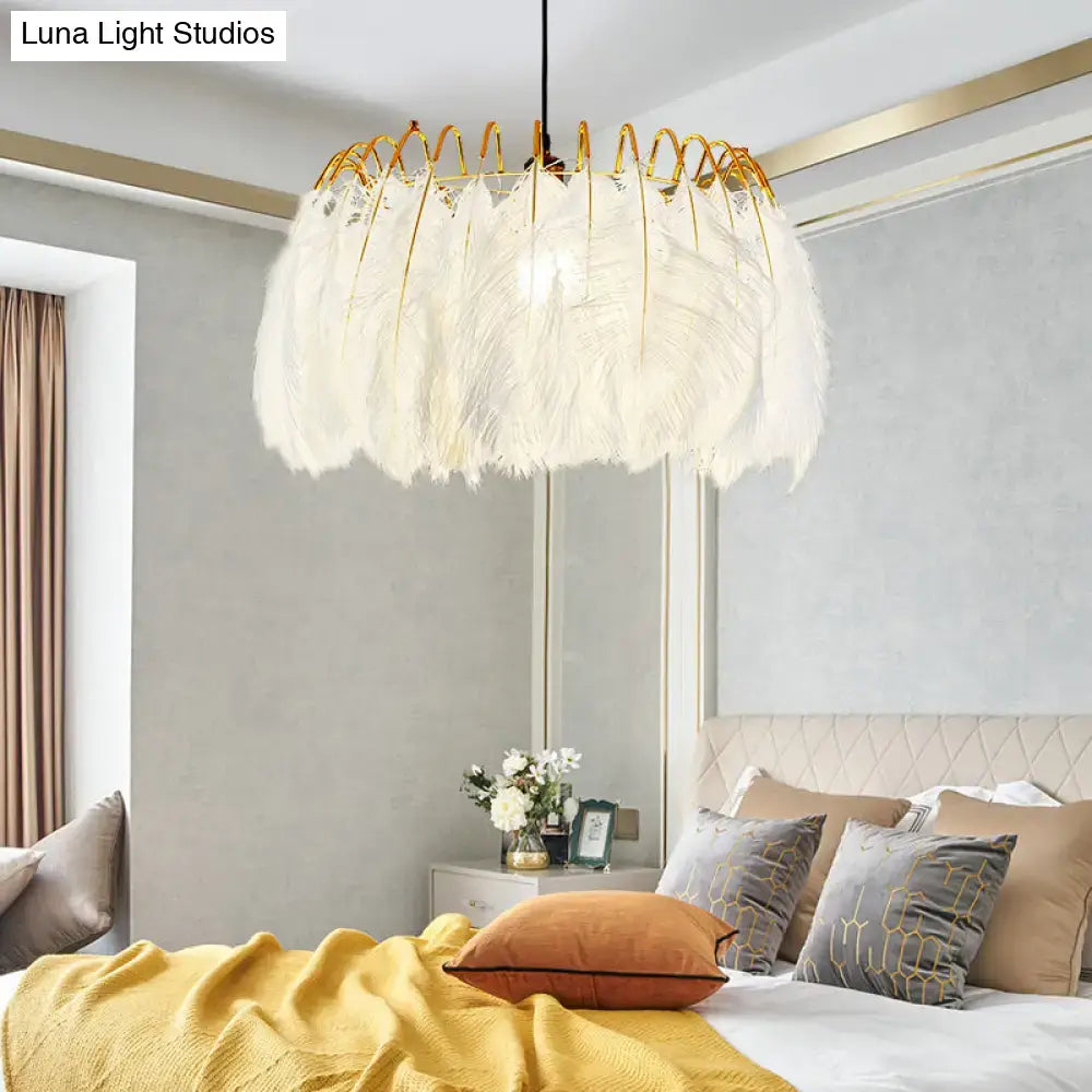 Modern white feather chandelier with gold-toned metal frame for elegant living room pendant lighting