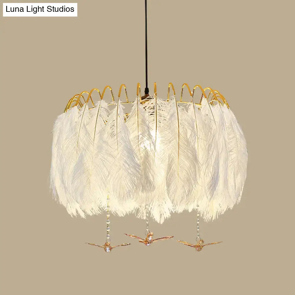 Modern white feather chandelier with gold-toned metal frame and decorative bird charms for living room pendant light