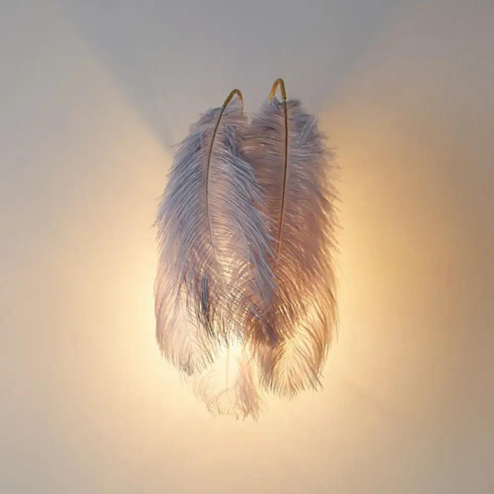 Modern white feather wall sconce featuring soft white ostrich feathers with golden hooks for bedroom single bulb light