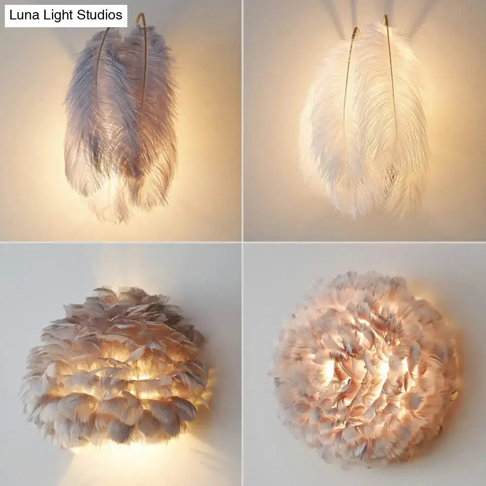 Modern white feather wall sconce with layered ostrich feathers in soft white and muted gray tones for bedroom lighting