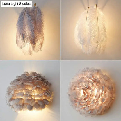 Modern white feather wall sconce with layered ostrich feathers in soft white and muted gray tones for bedroom lighting