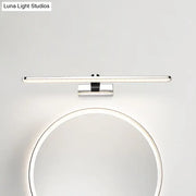 Modern white finish wall light bathroom sconce with chrome finish and led bulb mounted above a circular mirror