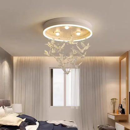 Modern white flying bird ceiling light for kids bedroom with a white base and hanging crystal bird ornaments decorbites flying bird
