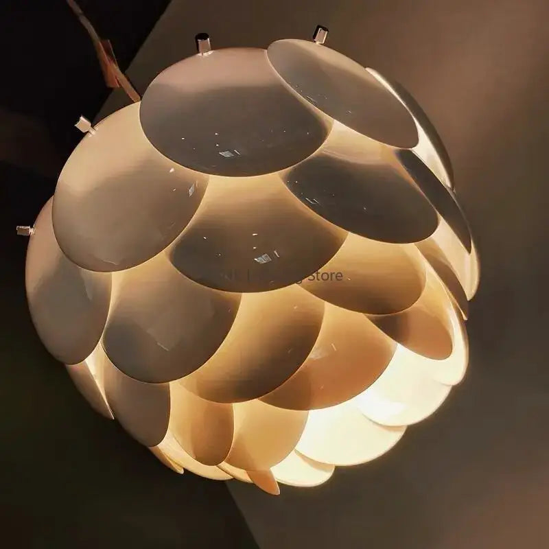 Modern white french ceramic chandelier pendant light with spherical metallic discs emitting warm glow decorbites french ceramic